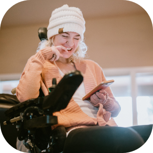 female ndis participant in a wheelchair using telehealth service